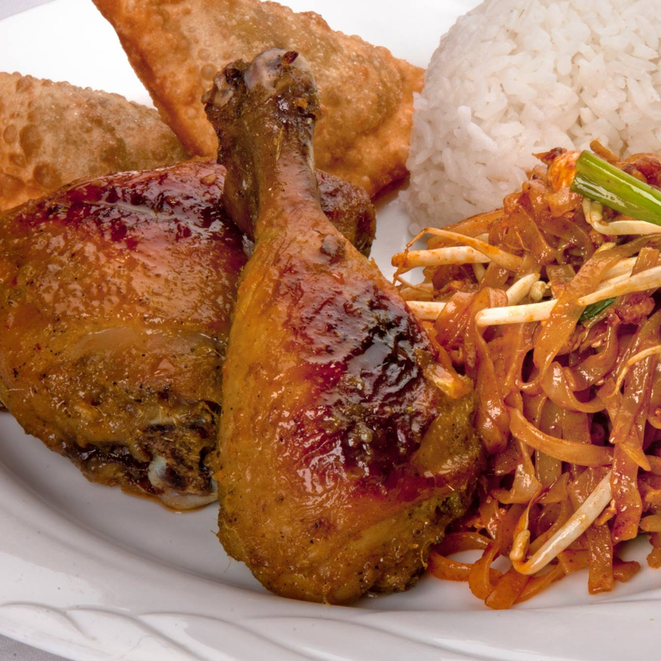 Thai Tangerine's grilled chicken, fried wontons, Pad Thai, and white rice on a plate.