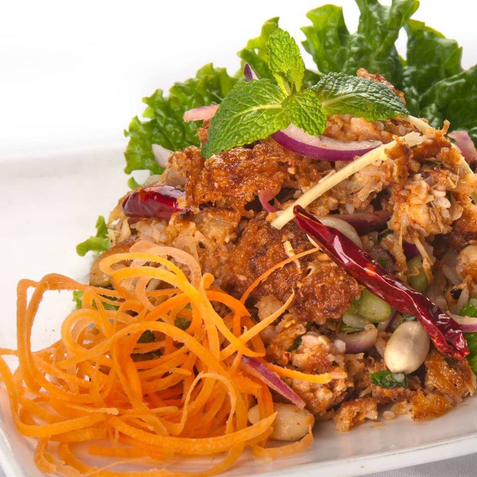 Crispy Thai salad with fried rice, red onions, mint, dried chilies, and shredded carrots.